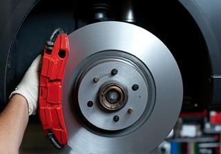 Mechanic inspecting a car's brake disc.